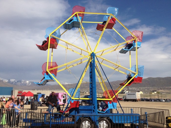 A woman rides a carnival ferris wheel