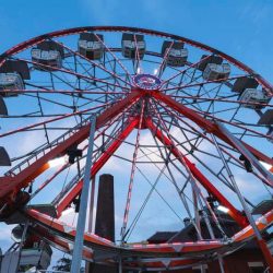 A woman rides a carnival ferris wheel