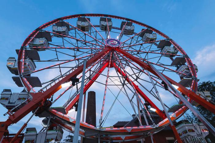 A woman rides a carnival ferris wheel