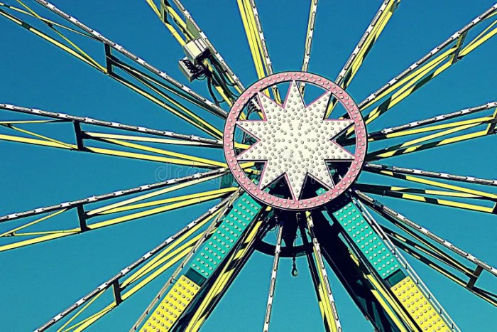 A woman rides a carnival ferris wheel