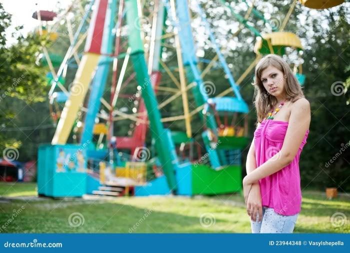 A woman rides a carnival ferris wheel